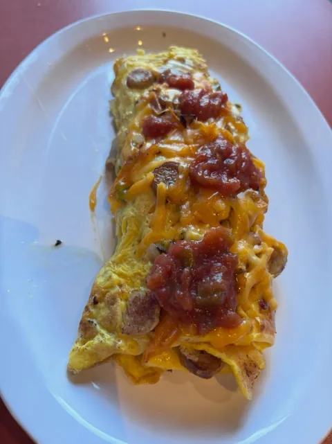Sausage and cheddar omelette topped with salsa