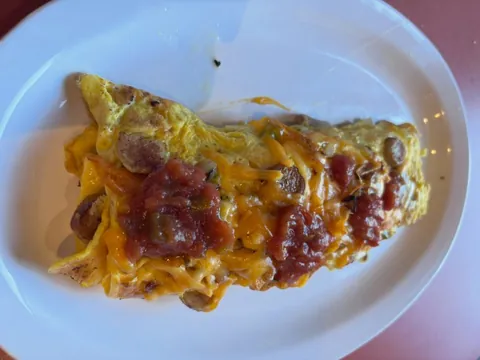 Sausage and cheddar omelette topped with salsa