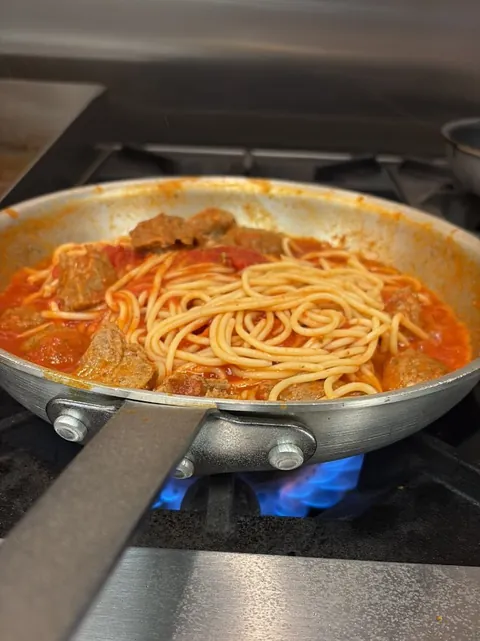 Spaghetti and meatballs in marinara, finishing in a pan on the stove