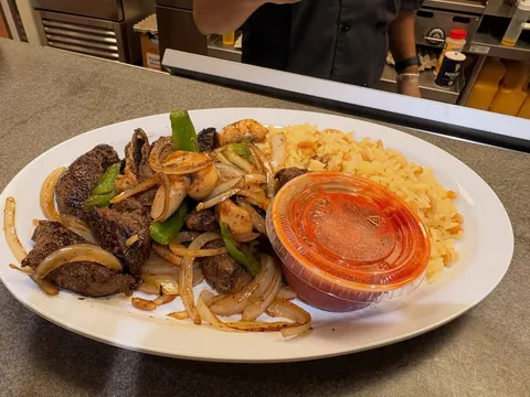 Steak tips with grilled onions and peppers, shrimp and rice pilaf